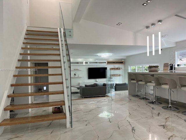 stairway featuring lofted ceiling