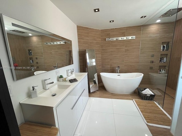 bathroom featuring separate shower and tub, tile patterned flooring, vanity, and tile walls