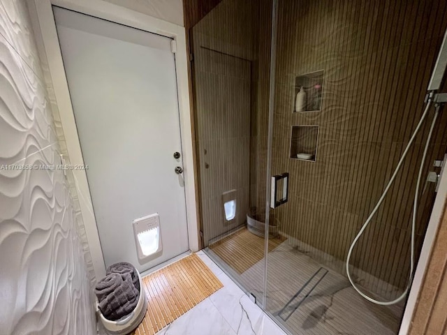 bathroom with a shower with shower door