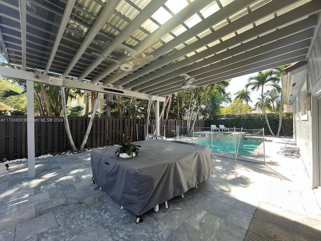 view of patio with a fenced in pool and area for grilling