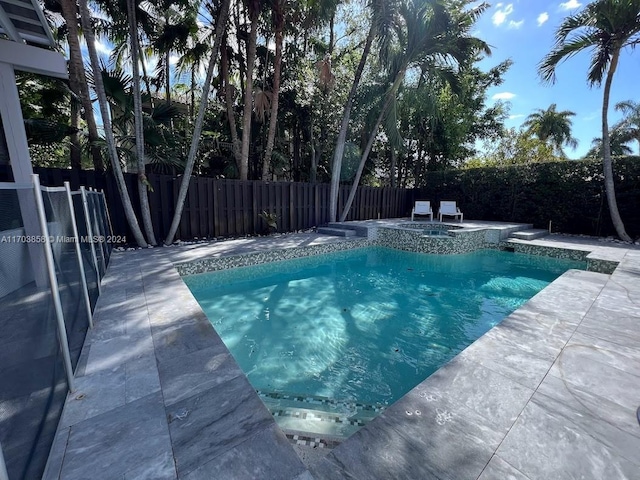 view of pool with an in ground hot tub and a patio