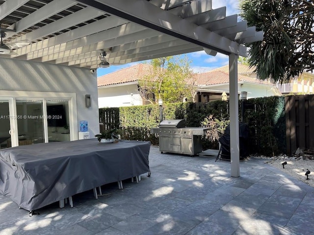 view of patio / terrace with a grill and a pergola