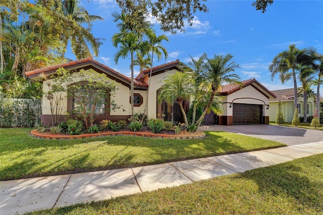 mediterranean / spanish-style home featuring stucco siding, a tile roof, decorative driveway, and a garage