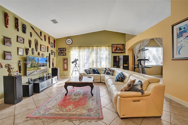 living room featuring visible vents, baseboards, lofted ceiling, arched walkways, and light tile patterned flooring