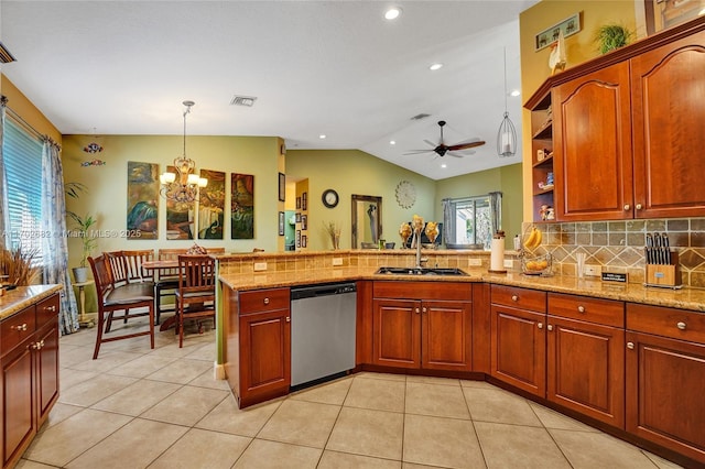 kitchen featuring pendant lighting, light tile patterned floors, a peninsula, stainless steel dishwasher, and a sink