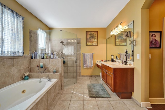 full bathroom with vanity, a tub with jets, baseboards, a stall shower, and tile patterned floors