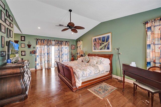 bedroom with hardwood / wood-style flooring, ceiling fan, and lofted ceiling