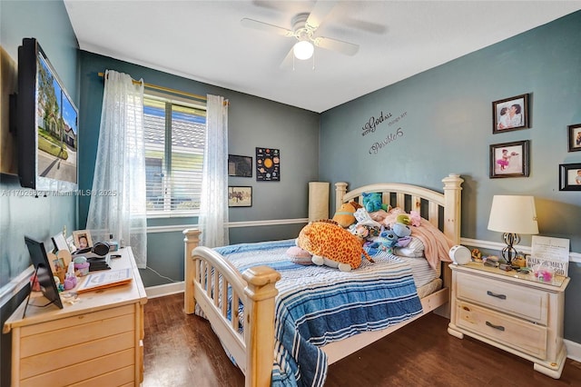 bedroom featuring a ceiling fan, wood finished floors, and baseboards