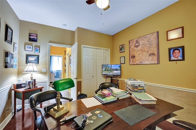 office with dark wood finished floors and ceiling fan