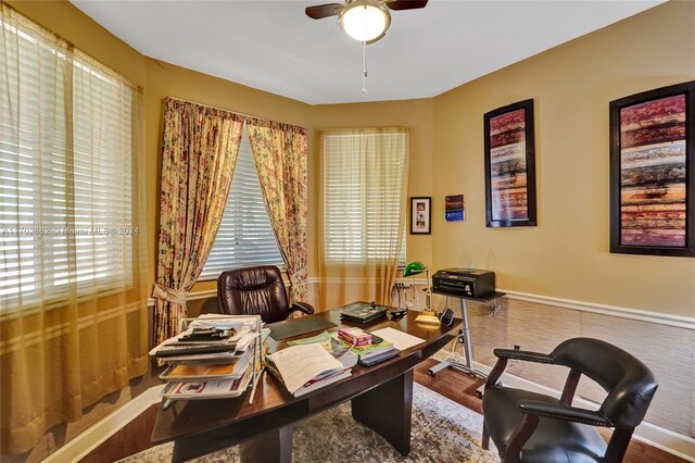 home office featuring wood-type flooring and ceiling fan