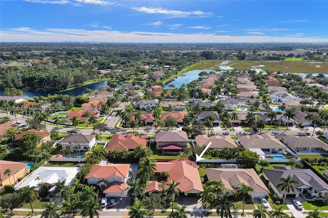 drone / aerial view featuring a residential view and a water view