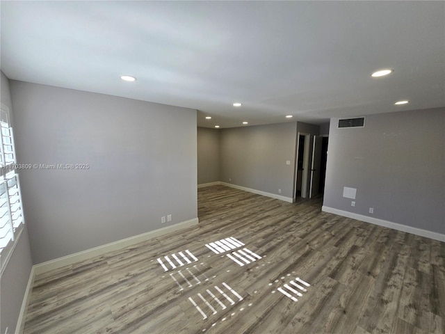 spare room with dark hardwood / wood-style flooring