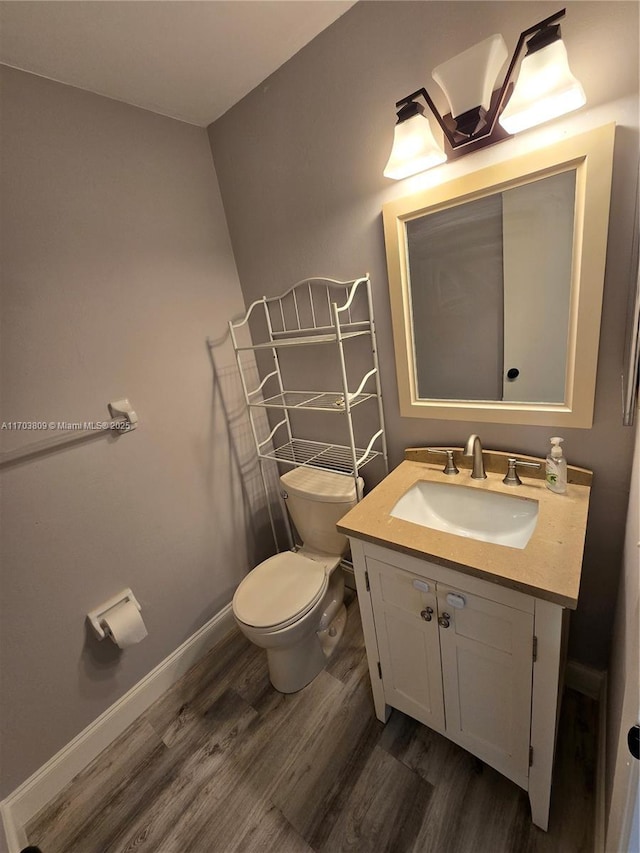 bathroom featuring hardwood / wood-style flooring, vanity, and toilet