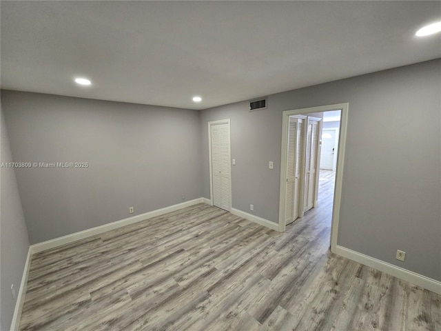 unfurnished room with light hardwood / wood-style flooring