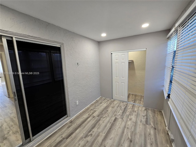 unfurnished room with wood-type flooring