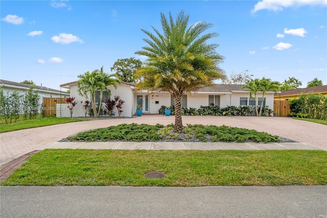 ranch-style house with a front lawn