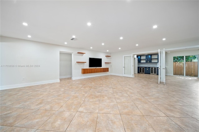 unfurnished living room featuring light tile patterned flooring