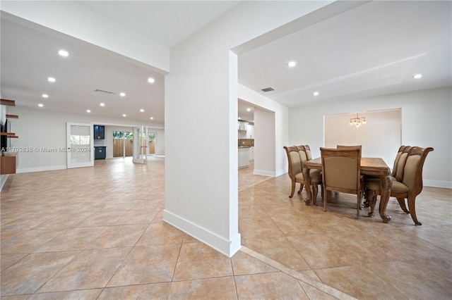 dining room featuring a notable chandelier and light tile patterned flooring