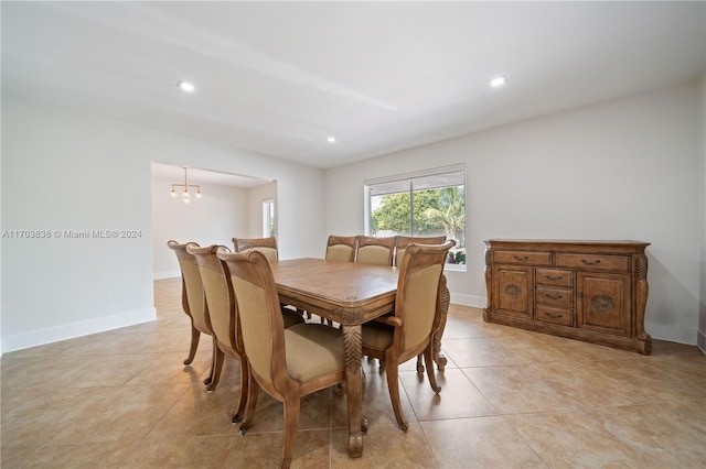 dining area featuring a notable chandelier and light tile patterned floors