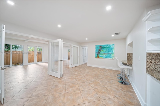 interior space with french doors and light tile patterned floors