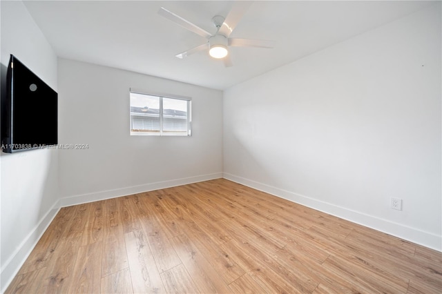 spare room with light wood-type flooring and ceiling fan