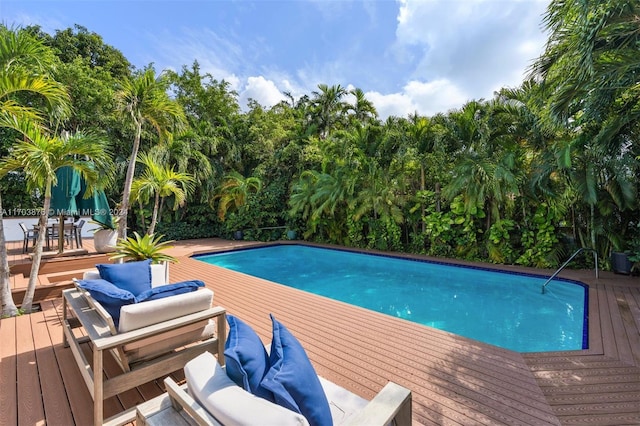 view of swimming pool with outdoor lounge area and a deck