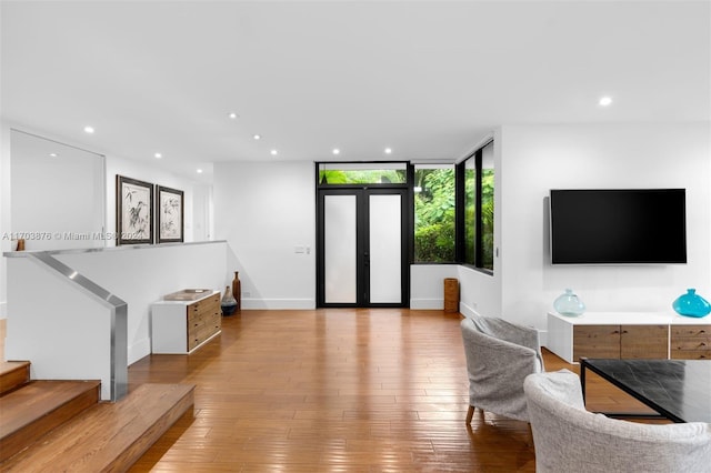 living room with light hardwood / wood-style floors and floor to ceiling windows