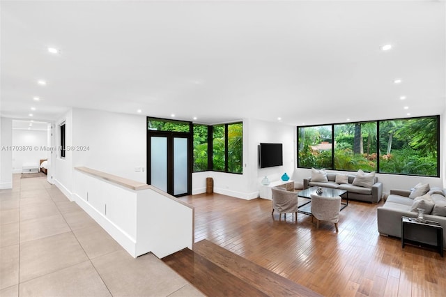 living room featuring floor to ceiling windows and light hardwood / wood-style flooring