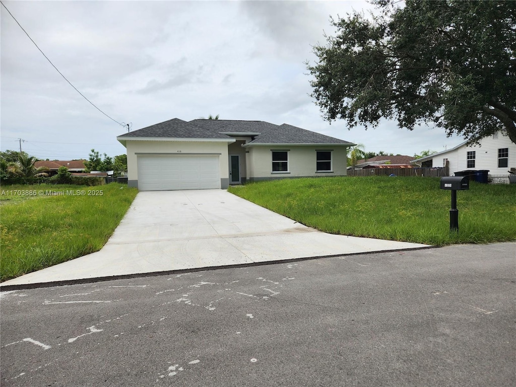 view of front of house with a garage and a front lawn