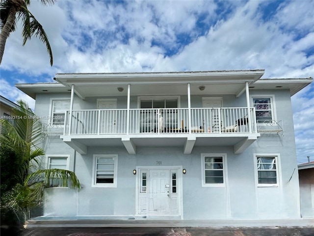 view of front of house featuring a balcony