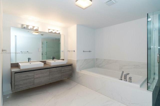 bathroom with vanity and shower with separate bathtub