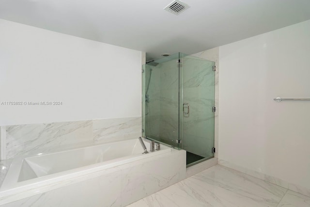 bathroom with separate shower and tub