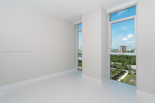 unfurnished room with light tile patterned floors