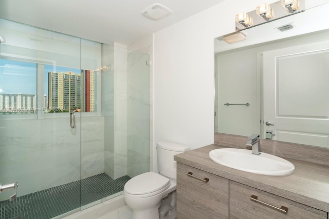 bathroom featuring vanity, toilet, and a shower with shower door