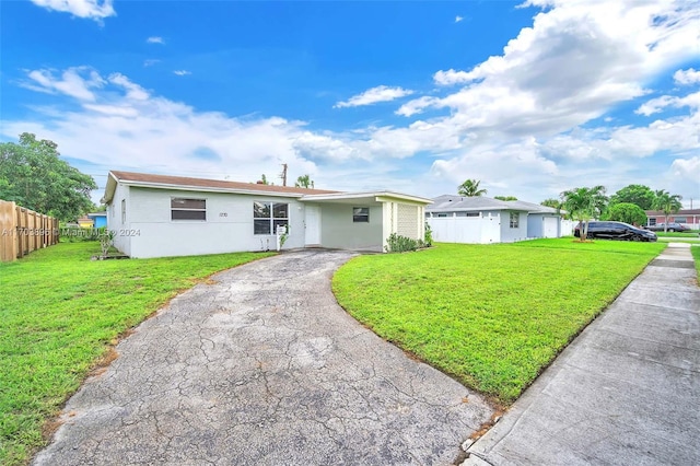 ranch-style home with a front lawn