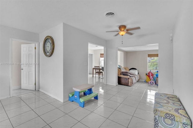 tiled living room featuring ceiling fan