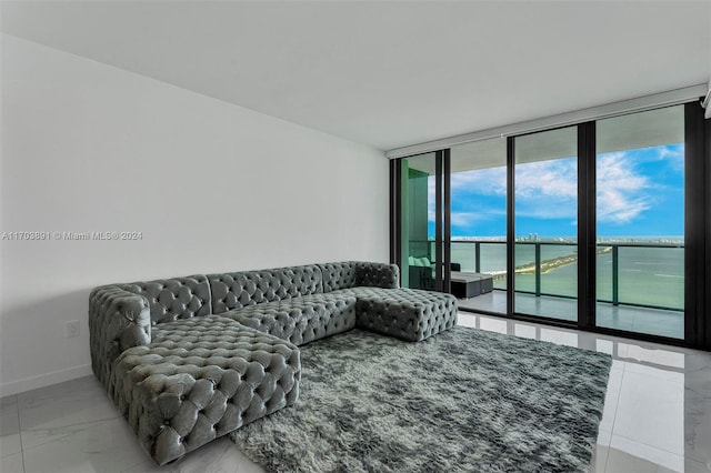 living room with a water view and expansive windows