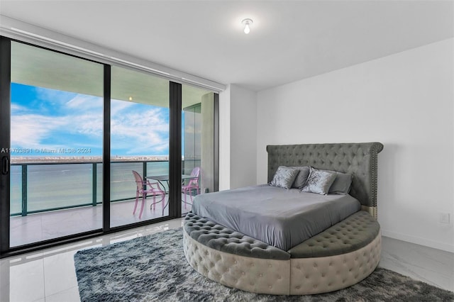 bedroom featuring access to outside and a water view