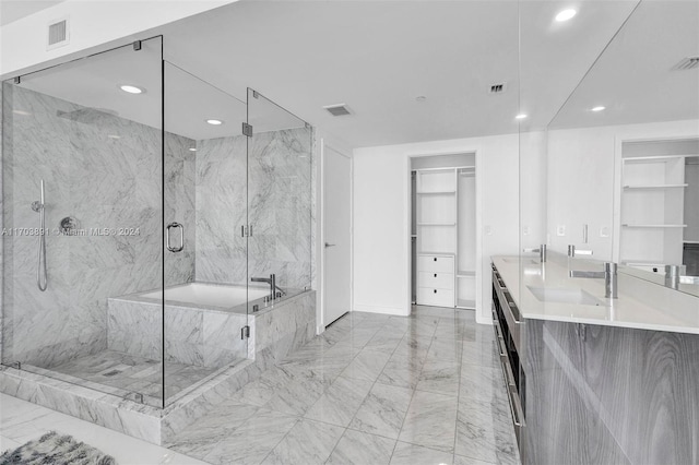 bathroom featuring vanity and separate shower and tub