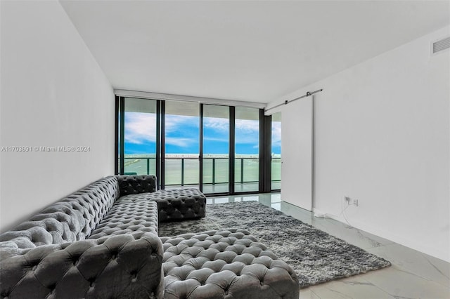 living room with floor to ceiling windows and a water view