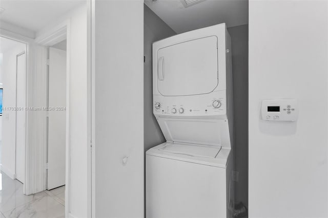 washroom featuring stacked washer and clothes dryer