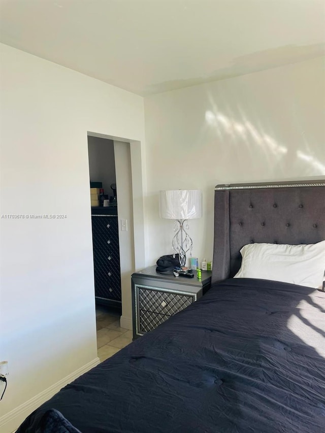 bedroom with light tile patterned floors