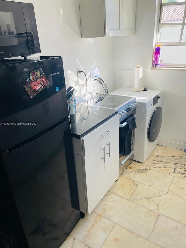 kitchen with white cabinets, black fridge, white stove, and washer / clothes dryer