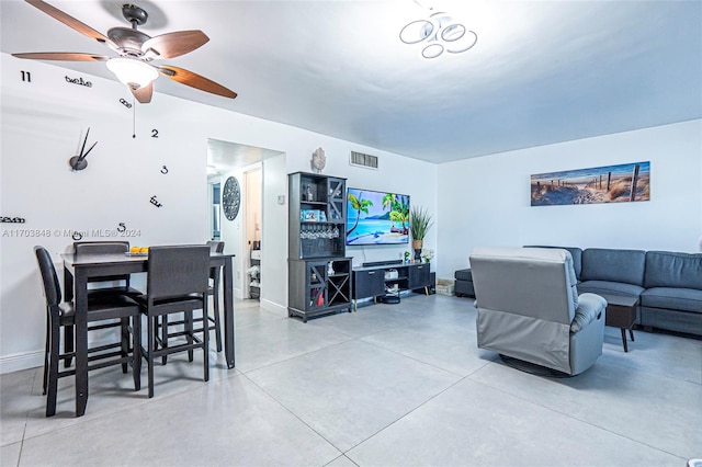 living room featuring ceiling fan and concrete flooring