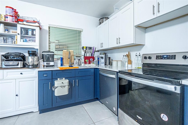 kitchen with white cabinetry, blue cabinets, light tile patterned floors, and appliances with stainless steel finishes