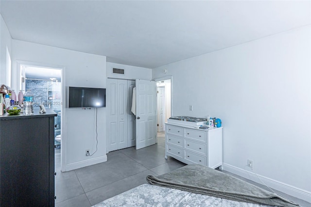 bedroom featuring tile patterned floors and a closet