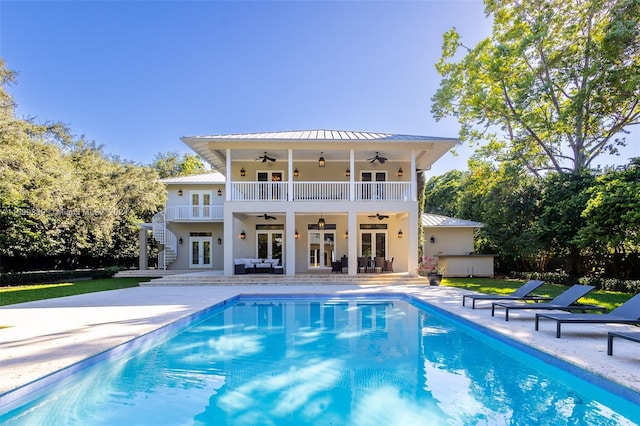 rear view of property with ceiling fan, a patio area, and french doors