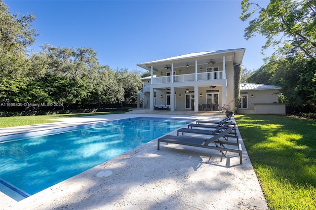 view of swimming pool featuring ceiling fan, a patio area, a yard, and french doors