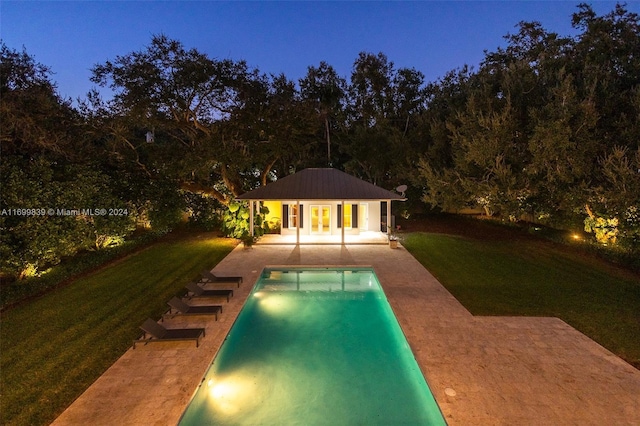 view of pool with an outbuilding, a yard, and a patio area