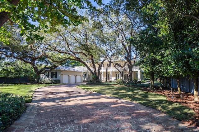 view of front of house with a garage and a front lawn